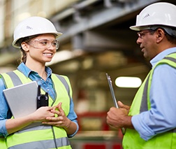 Female construction apprentice talks with mentor