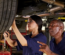 Female mechanic apprentice with male mentor